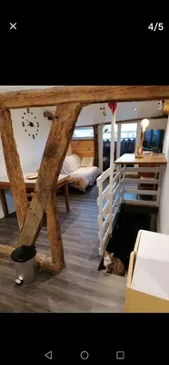 a room with a bunk bed and a clock on the wall at bel appartement in Mirepoix