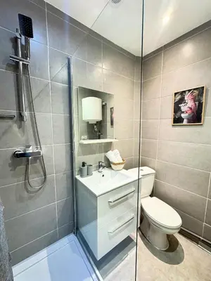 a bathroom with a toilet and a glass shower at Narbonne centre Dame Nature in Narbonne