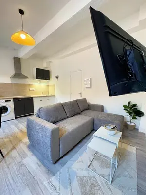 a living room with a couch and a flat screen tv at Narbonne centre Dame Nature in Narbonne