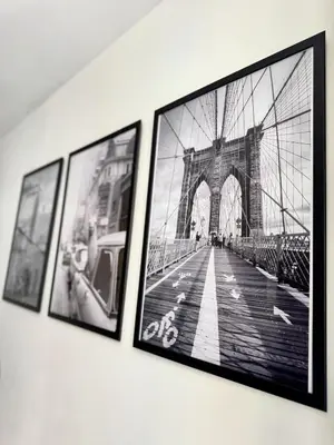 a group of framed pictures of a bridge on a wall at Narbonne centre New york in Narbonne
