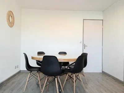 a conference room with a wooden table and chairs at Sun Of Gruissan in Gruissan