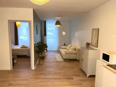 a living room with a couch and a table at Henri ll l Terrasse l Proche gare & Centre ville in Castres