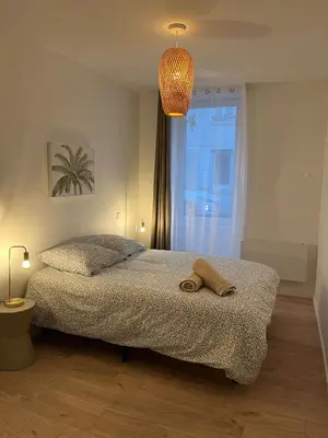 a bedroom with a bed with a towel on it at Henri ll l Terrasse l Proche gare & Centre ville in Castres