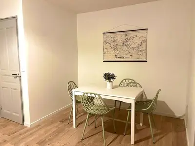 a white table and chairs with a map on the wall at Henri ll l Terrasse l Proche gare & Centre ville in Castres