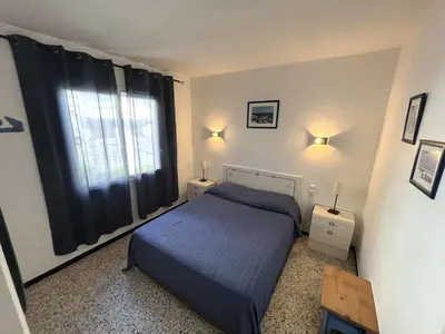 a small bedroom with a bed and a window at Maison 2 pièces 4 couchages PORT LA NOUVELLE PN000-042 in Port-la-Nouvelle