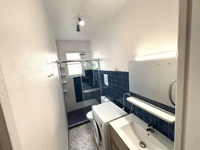 a bathroom with a toilet and a sink and a mirror at Maison 2 pièces 4 couchages PORT LA NOUVELLE PN000-042 in Port-la-Nouvelle