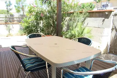 a white table and chairs on a patio at Maison 2 pièces 4 couchages PORT LA NOUVELLE PN000-042 in Port-la-Nouvelle