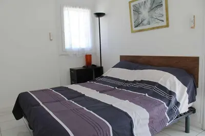a bedroom with a bed with a blanket on it at Maison 6 couchages - PORT LA NOUVELLE PN000-053 in Port-la-Nouvelle