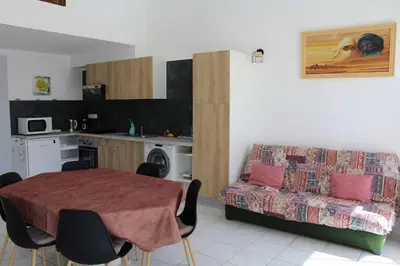 a living room with a table and a couch at Maison 6 couchages - PORT LA NOUVELLE PN000-053 in Port-la-Nouvelle