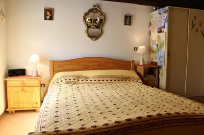 a bedroom with a bed and a mirror on the wall at Maison Studio mezz 2 couchages PORT LA NOUVELLE PN000-201 in Port-la-Nouvelle