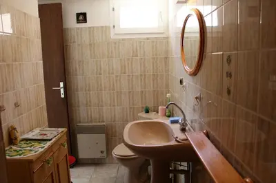 a bathroom with a sink and a toilet and a mirror at Maison Studio mezz 2 couchages PORT LA NOUVELLE PN000-201 in Port-la-Nouvelle