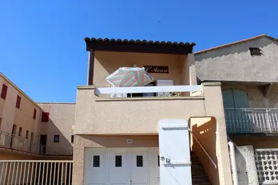 a building with an umbrella on top of it at Maison Studio mezz 2 couchages PORT LA NOUVELLE PN000-201 in Port-la-Nouvelle