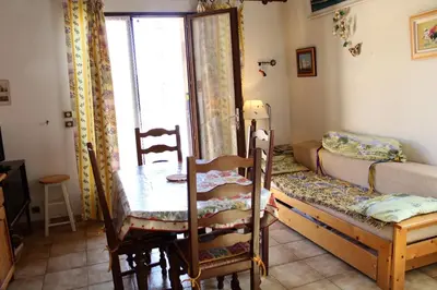 a room with a table and a bed and a table and chairs at Maison Studio mezz 2 couchages PORT LA NOUVELLE PN000-201 in Port-la-Nouvelle
