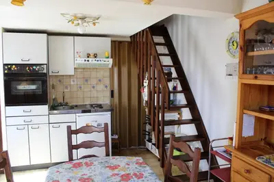a kitchen with a staircase leading up to a kitchen at Maison Studio mezz 2 couchages PORT LA NOUVELLE PN000-201 in Port-la-Nouvelle