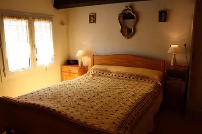 a bedroom with a bed and a mirror on the wall at Maison Studio mezz 2 couchages PORT LA NOUVELLE PN000-201 in Port-la-Nouvelle