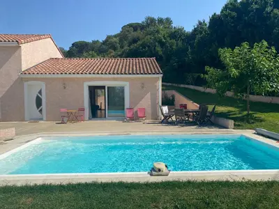 a large swimming pool in front of a house at MAISON 119m2 in Revel