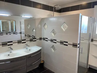 a bathroom with a sink and a shower at MAISON 119m2 in Revel