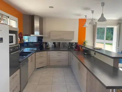 a large kitchen with a black counter top at MAISON 119m2 in Revel