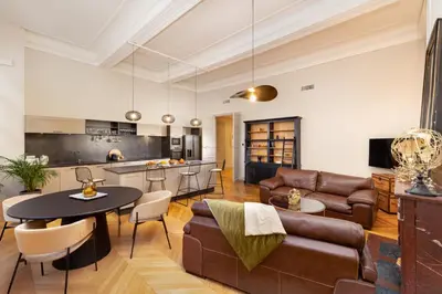 a living room with a couch and a table at L'Ecrin de Varenca in Carcassonne