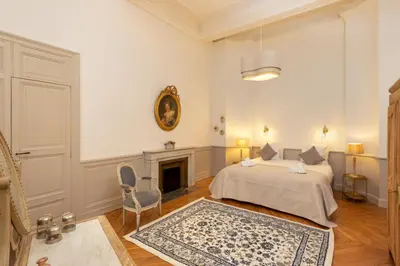a bedroom with a bed and a fireplace at L'Ecrin de Varenca in Carcassonne