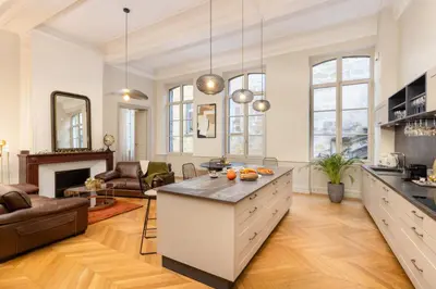 a kitchen with a large island in a living room at L'Ecrin de Varenca in Carcassonne