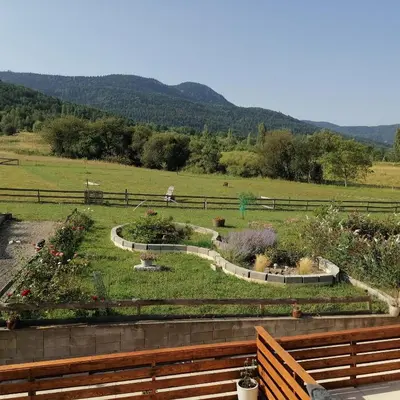 a view of a garden with flowers in a field at Gîte T3 terrasse Chalet in Puivert