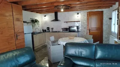 a kitchen with a table and a couch in a room at Gîte T3 terrasse Chalet in Puivert