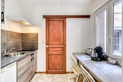a kitchen with a sink and a wooden door at El boulangerie - Central - Wifi in Carcassonne