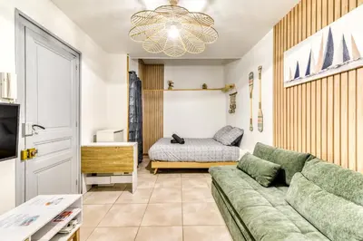 a living room with a couch and a bed at El boulangerie - Central - Wifi in Carcassonne