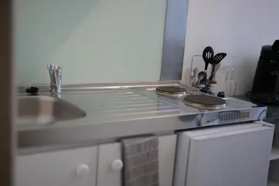 a kitchen with a sink and a counter top at Les 5 Lys in Carcassonne
