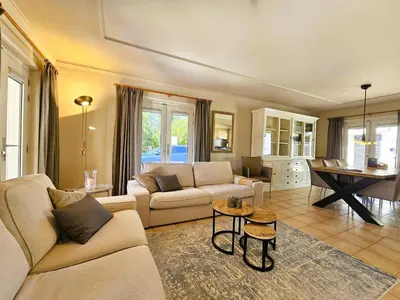 a living room with a couch and a table at Les Hirondelles in Beaufort