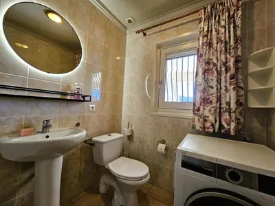 a bathroom with a toilet and a sink and a mirror at Les Hirondelles in Beaufort