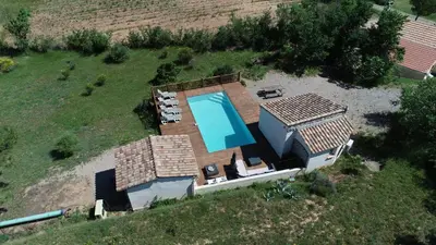 an aerial view of a house with a swimming pool at Villa L'Oustalet in Douzens