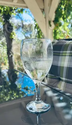 a wine glass sitting on top of a table at Villa L'Oustalet in Douzens