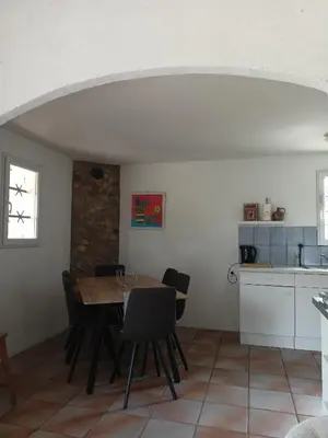 a kitchen and dining room with a table and chairs at Villa L'Oustalet in Douzens
