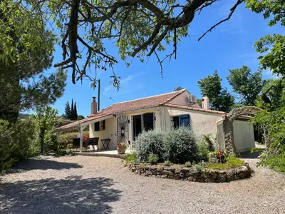 a house with a gravel driveway in front of it at Villa L'Oustalet in Douzens