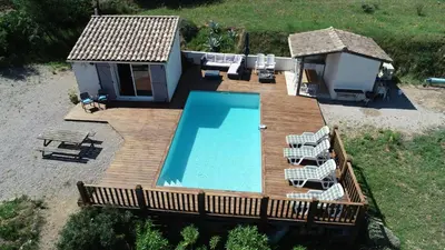 an overhead view of a wooden deck with a swimming pool at Villa L'Oustalet in Douzens
