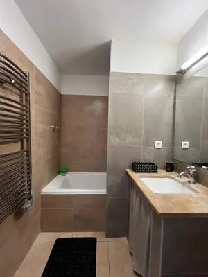 a bathroom with a bath tub and a sink at Maison T3 avec spa in Saint-Laurent-de-la-Cabrerisse