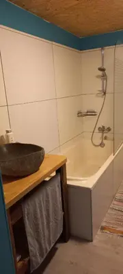 a bathroom with a sink and a bath tub at Maison calme in Payrin-Augmontel