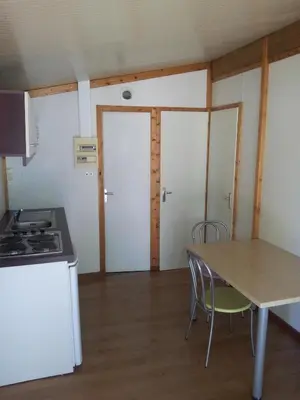 a kitchen and dining room with a table and chairs at La Bastide in Mazères