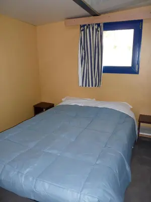 a bedroom with a large bed and a window at La Bastide in Mazères