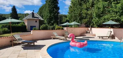 a swimming pool with a pink flamingo in the water at L'ECRIN DU LAC - Ô Cèpes in Mazamet