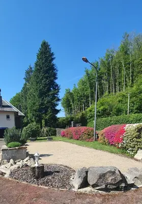 a park with flowers and a light pole at L'ECRIN DU LAC - Ô Cèpes in Mazamet