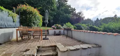 a patio with a table and chairs and a fence at L'ECRIN DU LAC - Ô Cèpes in Mazamet