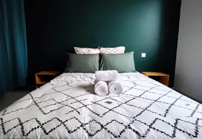 a bedroom with a bed with two towels on it at L'Atelier Cosy in Lézignan-Corbières