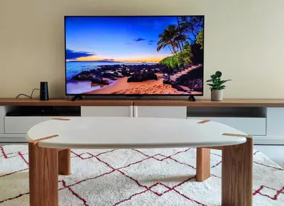 a living room with a tv on a table at L'Atelier Cosy in Lézignan-Corbières