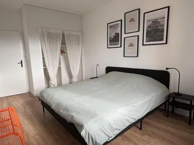 a room with two beds and a window at Appartement familial avec parking privatif in Carcassonne