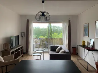 a patio with chairs and a table on a balcony at Appartement familial avec parking privatif in Carcassonne