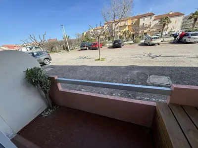 a balcony of a building with a parking lot at Appartement deux pièces Port la Nouvelle PN015-017 in Port-la-Nouvelle