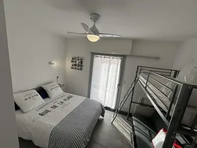 a bedroom with a bed and a ceiling fan at Appartement deux pièces Port la Nouvelle PN015-017 in Port-la-Nouvelle
